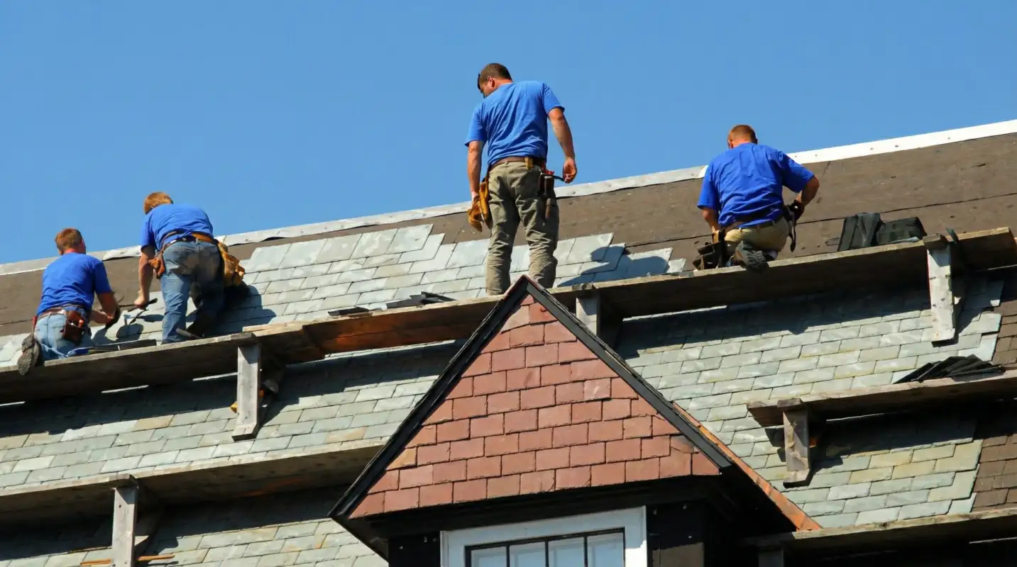 Roof replacement in progress with a team of professional contractors installing new shingles on a residential home in Allentown, PA